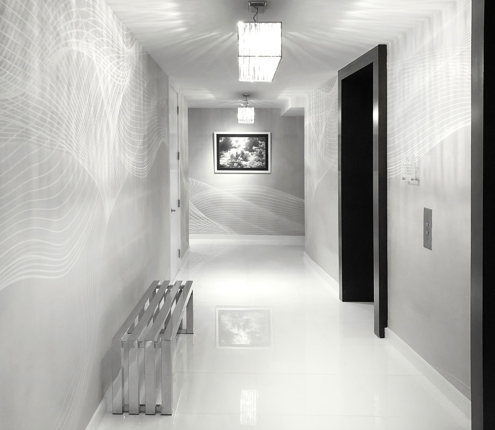 This is an example of a contemporary entry hall in Miami with grey walls and a double front door.