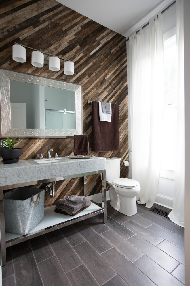 Photo of a mid-sized contemporary 3/4 bathroom in Indianapolis with open cabinets, white cabinets, an alcove shower, brown walls, ceramic floors, an undermount sink, marble benchtops, a hinged shower door, white benchtops, a two-piece toilet and brown floor.