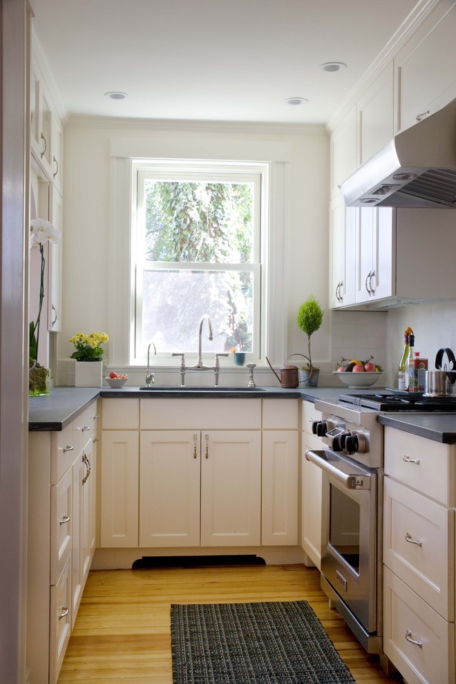 Inspiration for a small traditional separate kitchen in Boston with stainless steel appliances, recessed-panel cabinets, white cabinets and white splashback.