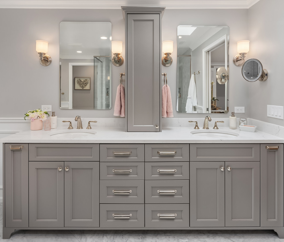 This is an example of an expansive traditional master bathroom in Seattle with grey cabinets, a freestanding tub, a double shower, a two-piece toilet, gray tile, marble, grey walls, marble floors, an undermount sink, engineered quartz benchtops, grey floor, a hinged shower door, multi-coloured benchtops and recessed-panel cabinets.