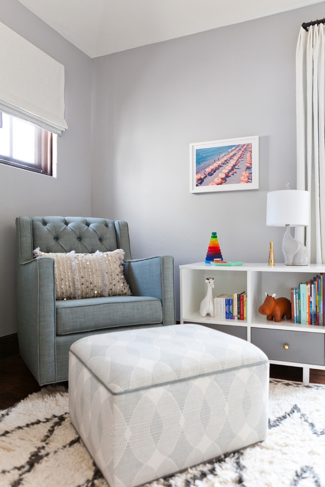 Photo of a mid-sized transitional gender-neutral nursery in Los Angeles with grey walls, medium hardwood floors and brown floor.