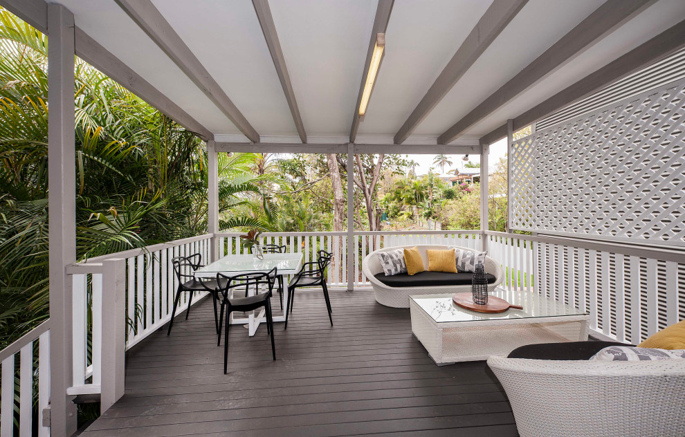 Large transitional backyard and first floor deck in Brisbane with a pergola and wood railing.