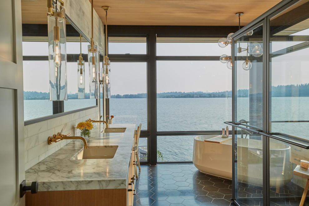 Example of a trendy master double-sink freestanding bathtub design in Seattle
