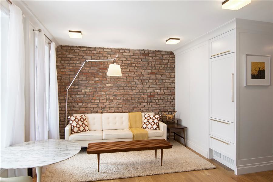 Inspiration for a small transitional formal and open concept light wood floor living room remodel in New York with white walls, no fireplace and no tv