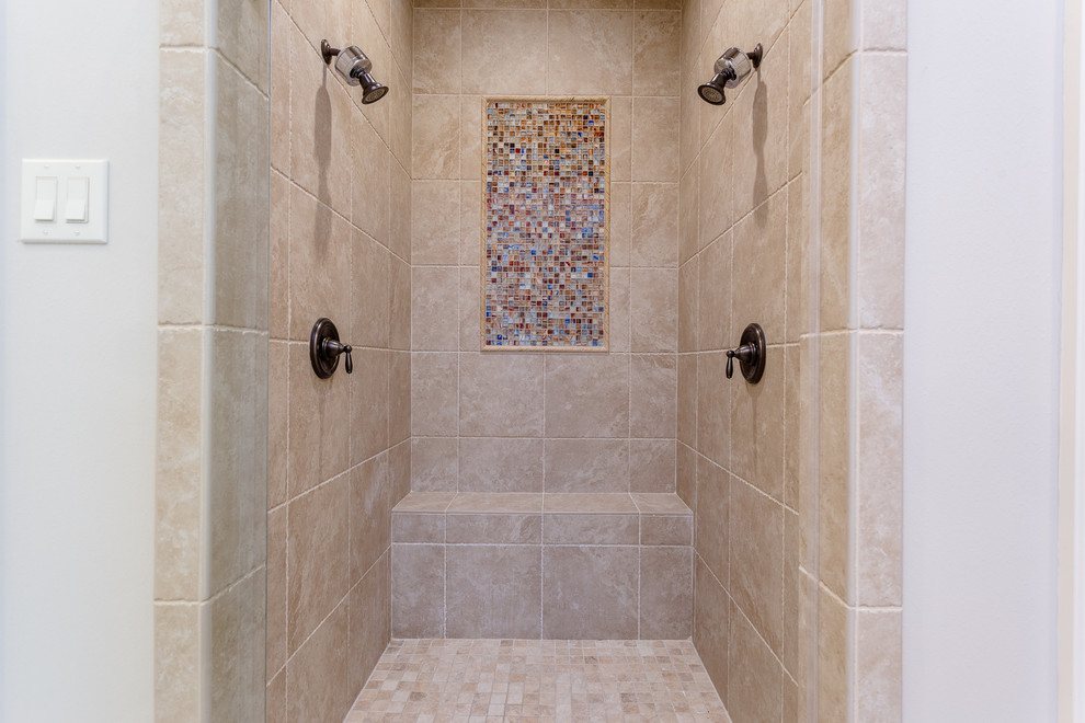 Inspiration for a large mediterranean master bathroom in Houston with recessed-panel cabinets, white cabinets, a drop-in tub, a curbless shower, a two-piece toilet, beige tile, travertine, beige walls, travertine floors, an undermount sink, granite benchtops, beige floor, an open shower and beige benchtops.