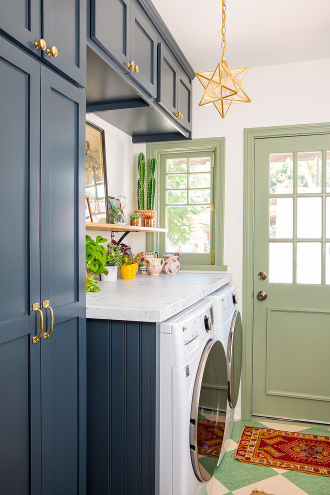 Inspiration for a mid-sized transitional single-wall utility room in Los Angeles with shaker cabinets, blue cabinets, marble benchtops, white walls, a side-by-side washer and dryer, multi-coloured benchtop, linoleum floors and green floor.