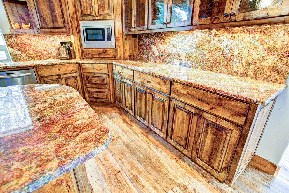 Inspiration for a large rustic u-shaped medium tone wood floor kitchen pantry remodel with a drop-in sink, glass-front cabinets, medium tone wood cabinets, beige backsplash, stainless steel appliances and an island