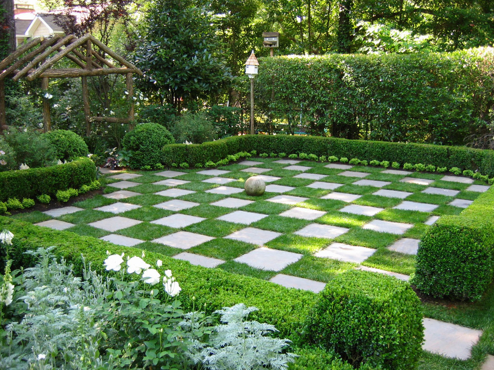 Photo of a traditional backyard formal garden in Atlanta with natural stone pavers.