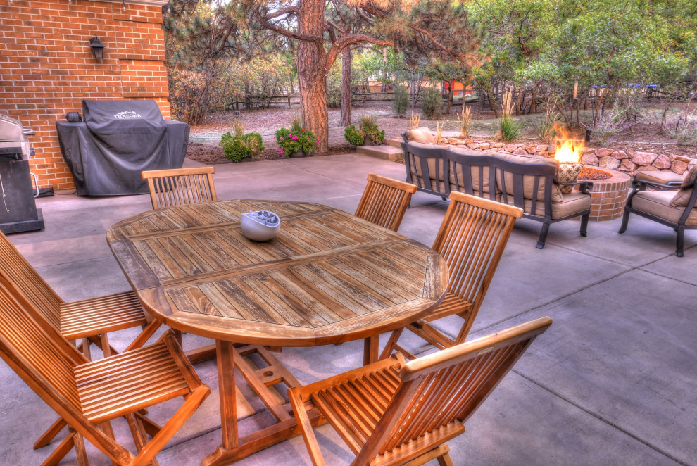 Large traditional backyard patio in Denver with a fire feature, concrete slab and no cover.
