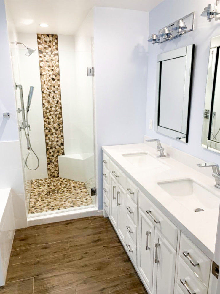 Large transitional master bathroom in Los Angeles with flat-panel cabinets, white cabinets, a corner tub, an alcove shower, white tile, cement tile, purple walls, medium hardwood floors, marble benchtops, brown floor, a hinged shower door, white benchtops and a double vanity.