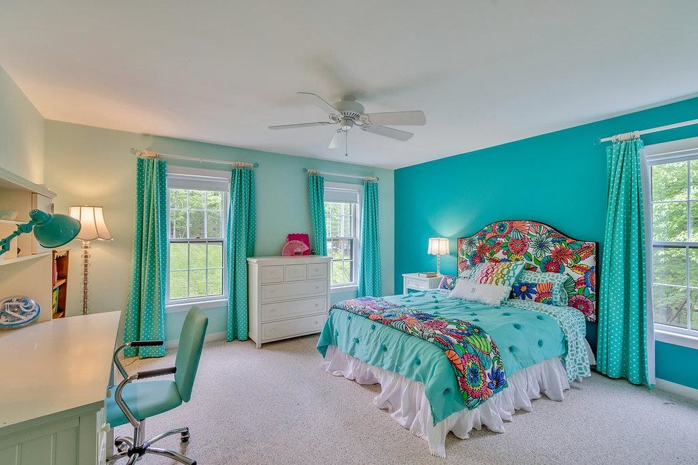 This is an example of a large transitional bedroom in Boston with blue walls, carpet and no fireplace.