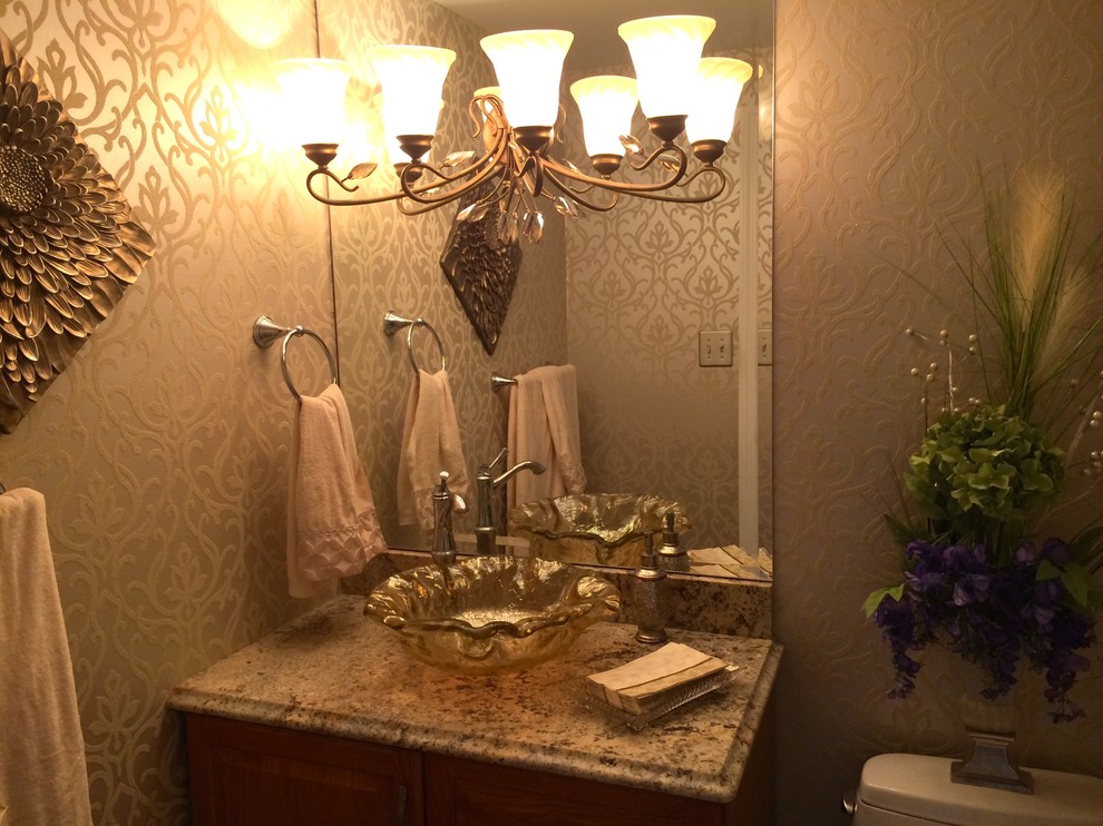 This is an example of a small transitional powder room in New Orleans with beige walls, a vessel sink, granite benchtops and beige benchtops.