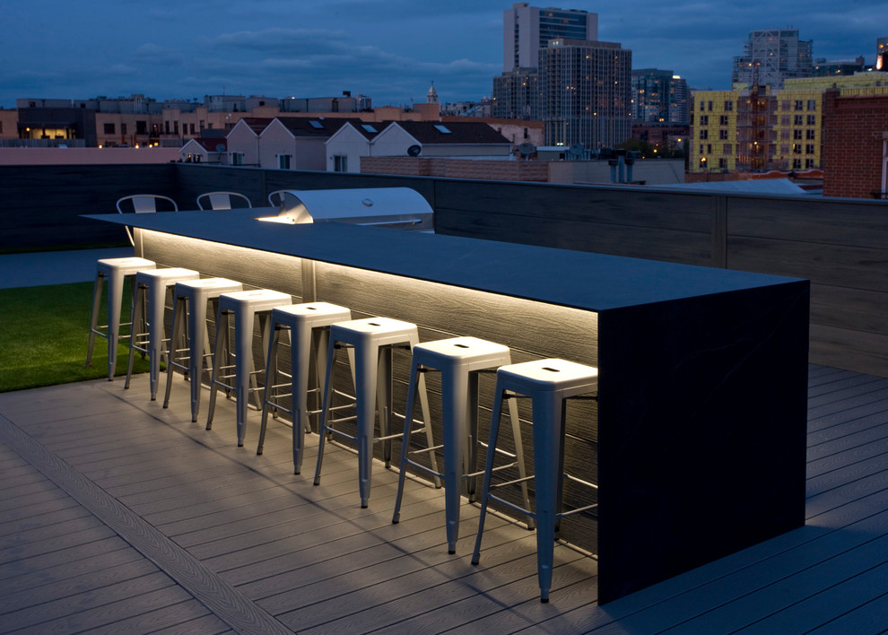 Photo of a large modern rooftop deck in Chicago with an outdoor kitchen and no cover.