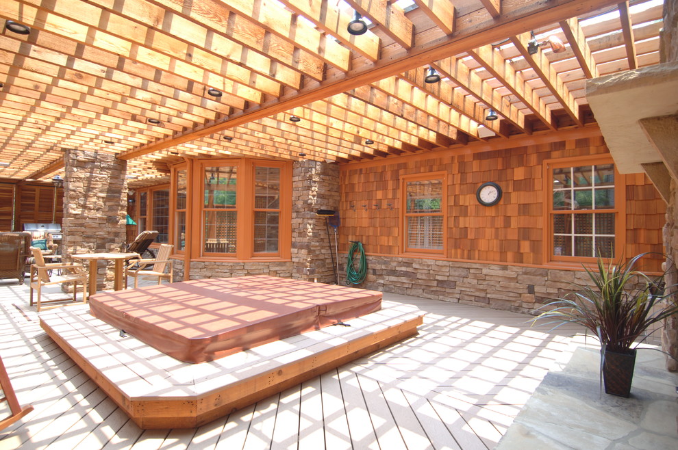 Huge mountain style backyard outdoor kitchen deck photo in Atlanta with a pergola