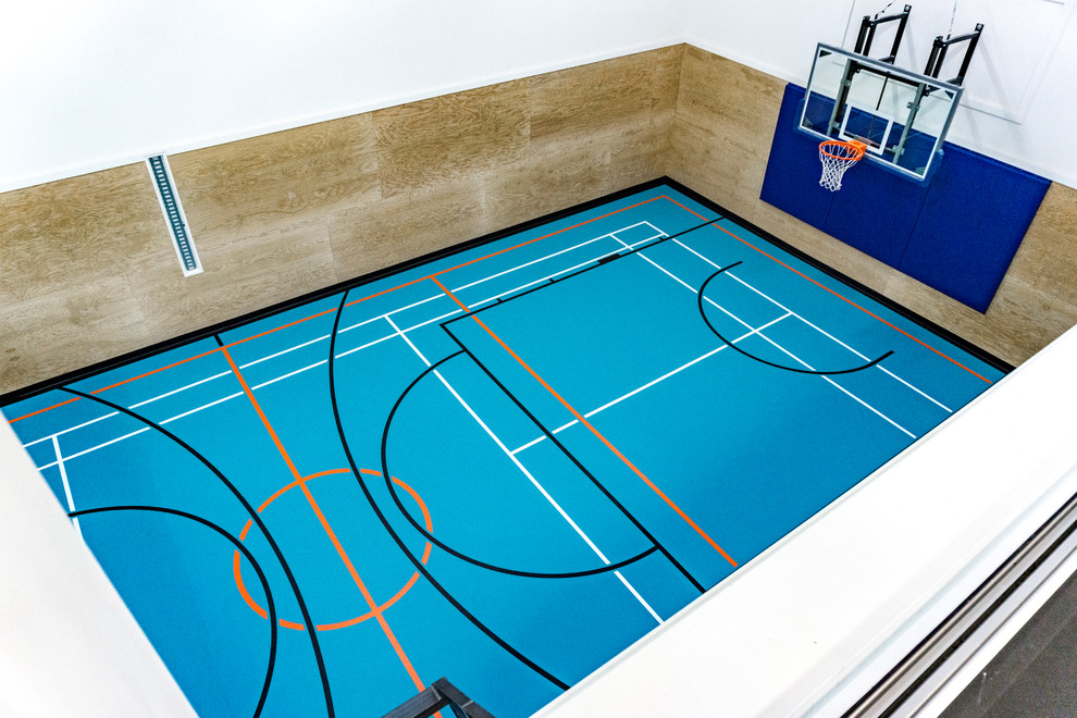 Photo of a large industrial indoor sport court in Edmonton with blue floor.