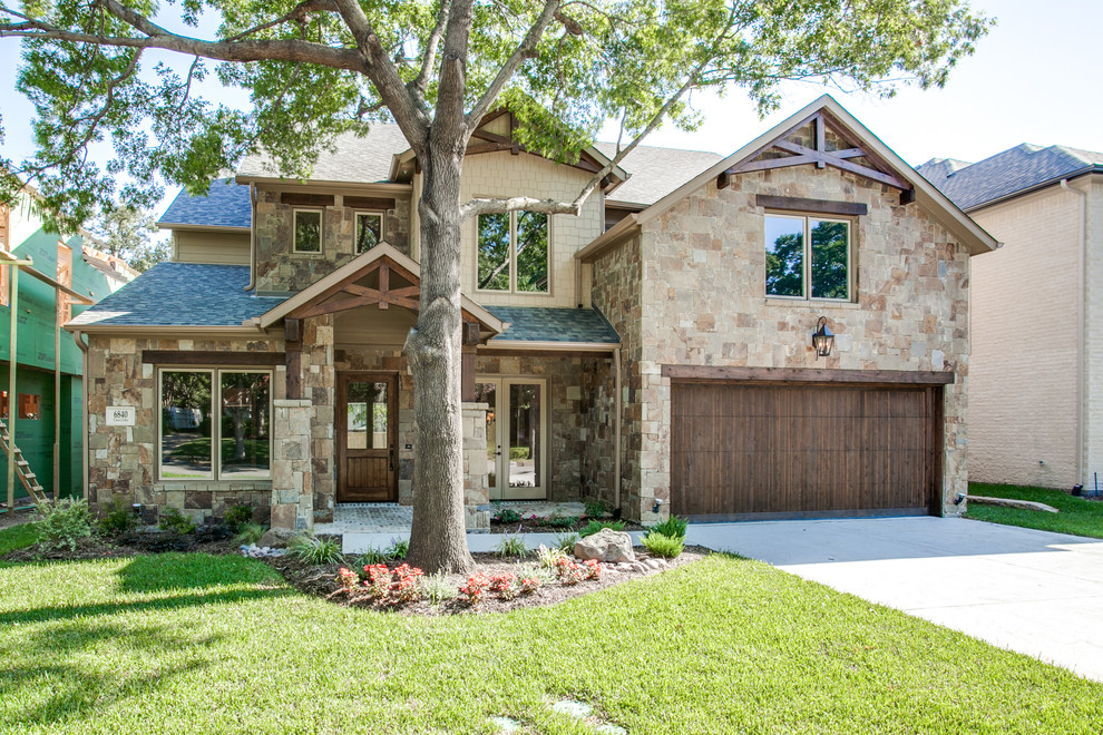 Inspiration for an arts and crafts two-storey exterior in Dallas with stone veneer.