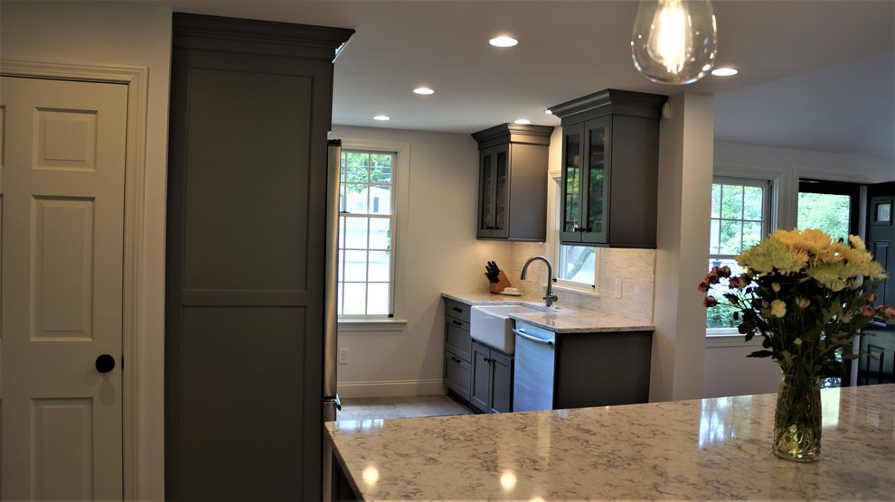 Open concept kitchen - mid-sized transitional galley porcelain tile and gray floor open concept kitchen idea in Boston with a farmhouse sink, recessed-panel cabinets, quartz countertops, white backsplash, porcelain backsplash, stainless steel appliances, an island and white countertops
