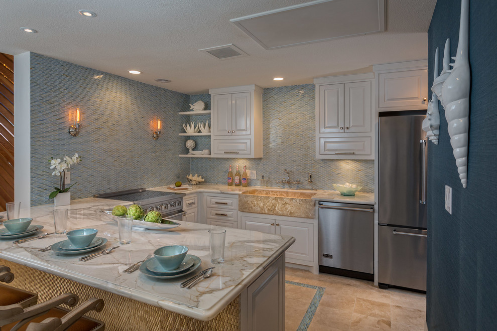 This is an example of a contemporary u-shaped kitchen in Austin with mosaic tile splashback, raised-panel cabinets, stainless steel appliances, a farmhouse sink, marble benchtops and blue splashback.