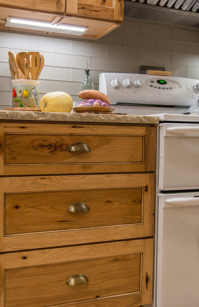 Mountain style ceramic tile and beige floor kitchen photo in Boston with a farmhouse sink, shaker cabinets, light wood cabinets, granite countertops, gray backsplash, subway tile backsplash and stainless steel appliances