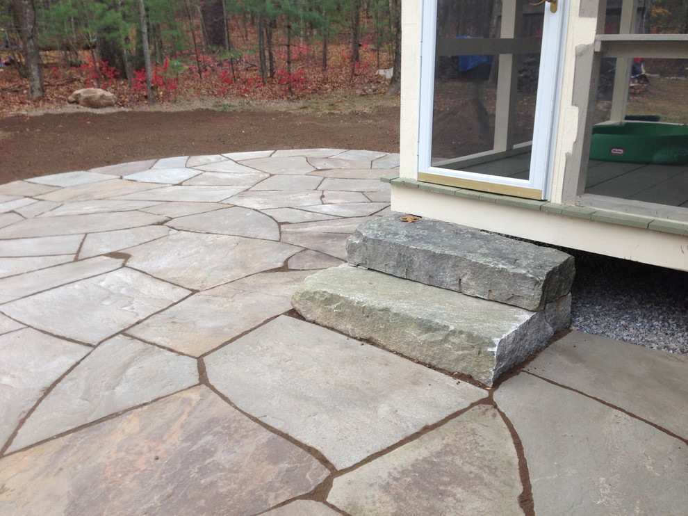 Design ideas for a country backyard garden in Manchester with natural stone pavers.