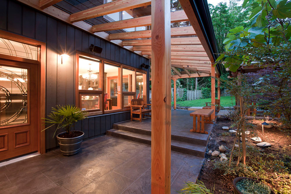 Photo of a large transitional backyard patio in Vancouver with tile and a pergola.