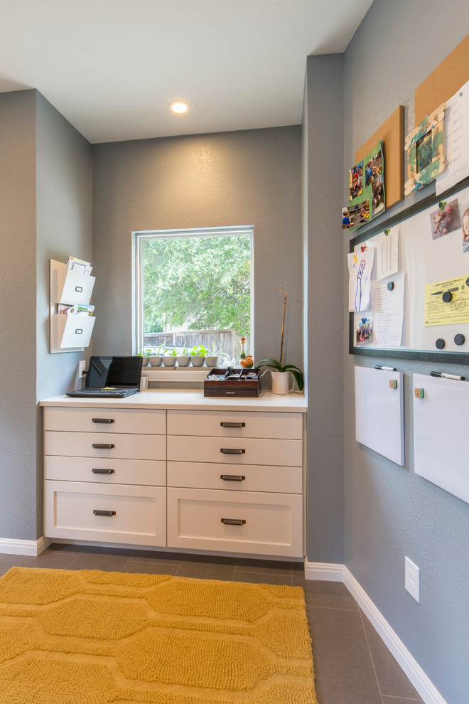 Inspiration for a mid-sized transitional porcelain tile mudroom remodel in Austin with gray walls and a white front door