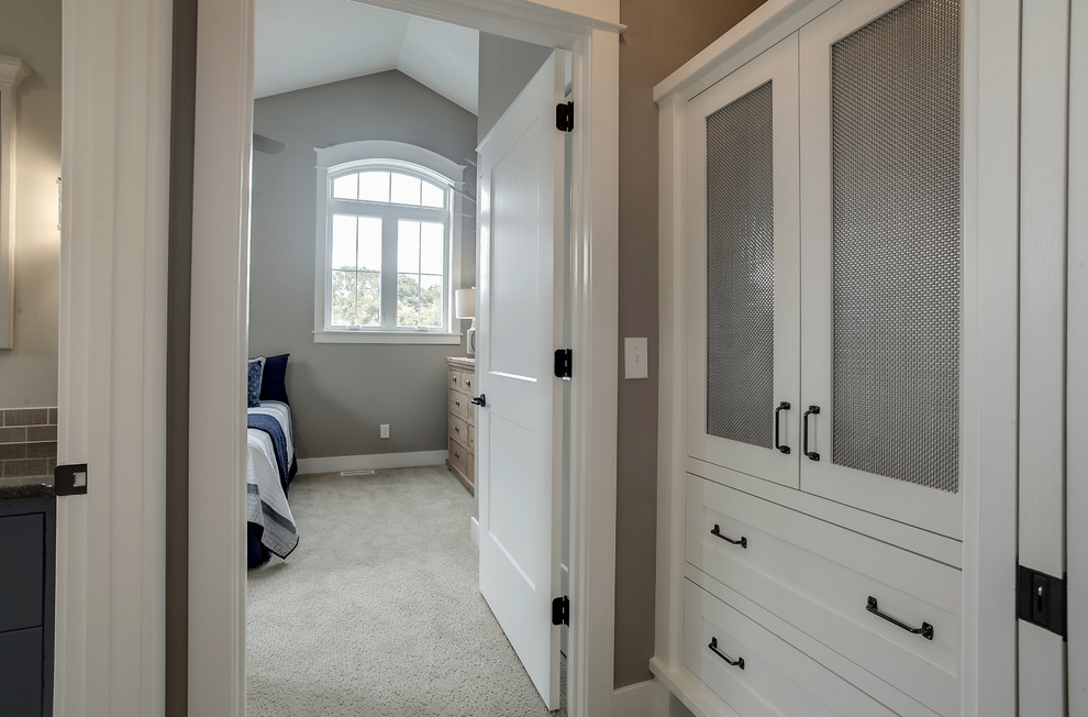Inspiration for a transitional carpeted hallway remodel in Grand Rapids with beige walls