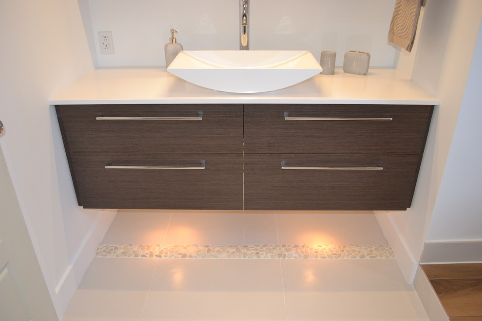 Design ideas for a small modern bathroom in Montreal with a vessel sink, flat-panel cabinets, dark wood cabinets, quartzite benchtops, a freestanding tub, brown tile, porcelain tile, white walls and porcelain floors.