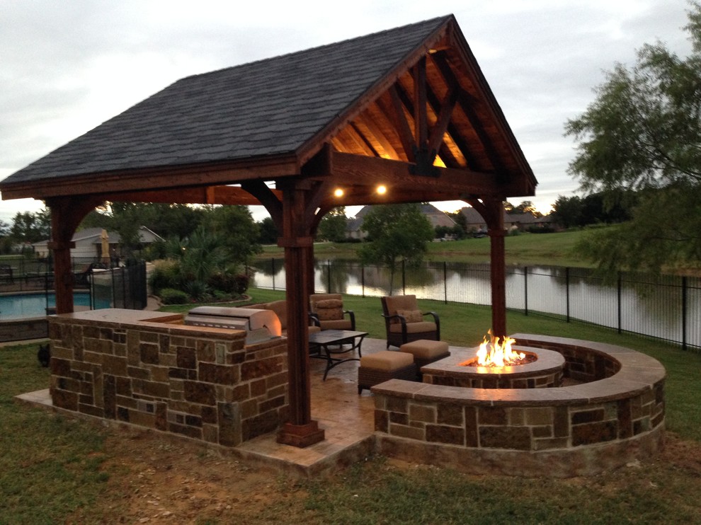Inspiration for a mid-sized arts and crafts backyard patio in Dallas with an outdoor kitchen, stamped concrete and a gazebo/cabana.