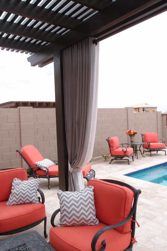 Photo of a contemporary backyard patio in Phoenix with a pergola.