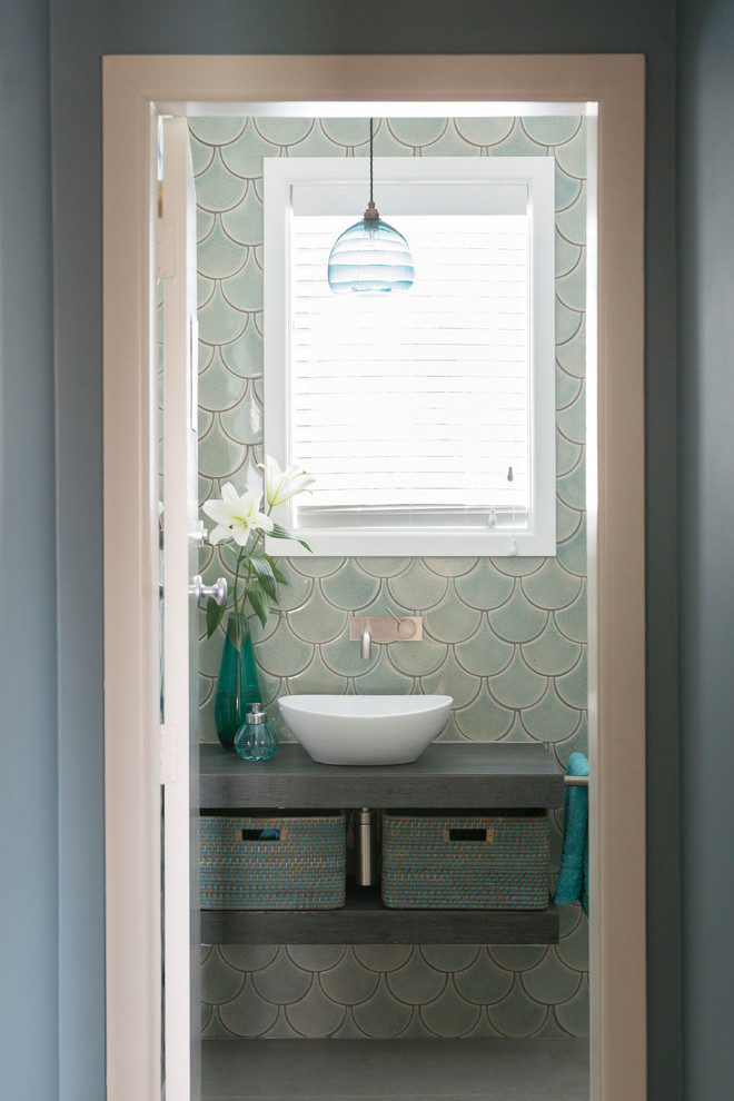 Photo of a small eclectic 3/4 bathroom in Other with open cabinets, grey cabinets, green tile, ceramic tile, ceramic floors, a vessel sink, tile benchtops, grey floor and blue walls.