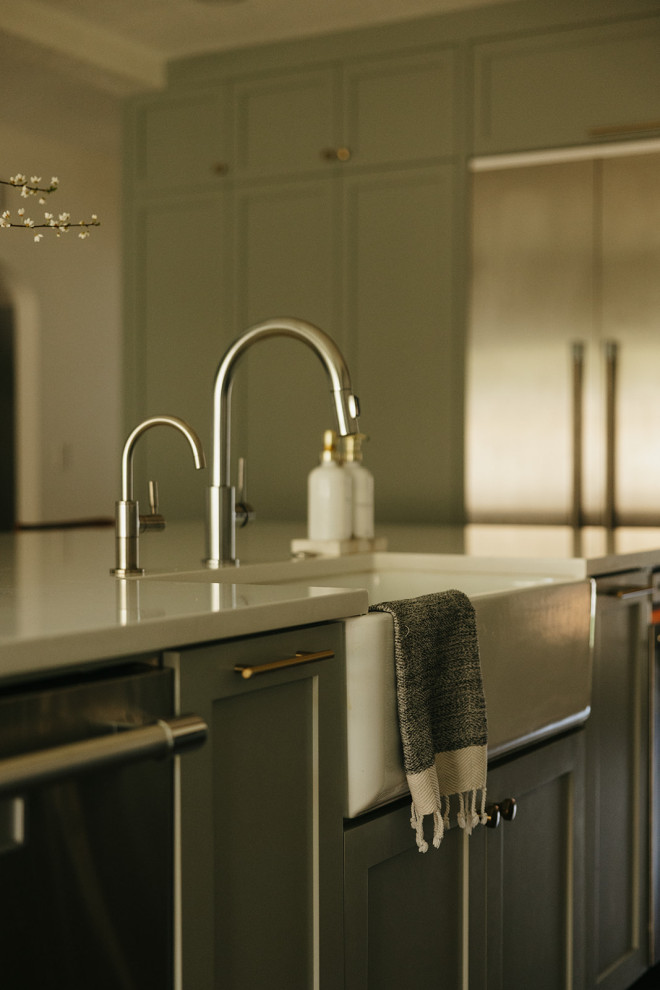 Inspiration for a transitional kitchen pantry remodel in Portland with a farmhouse sink, shaker cabinets, green cabinets, quartz countertops, stainless steel appliances, an island and white countertops