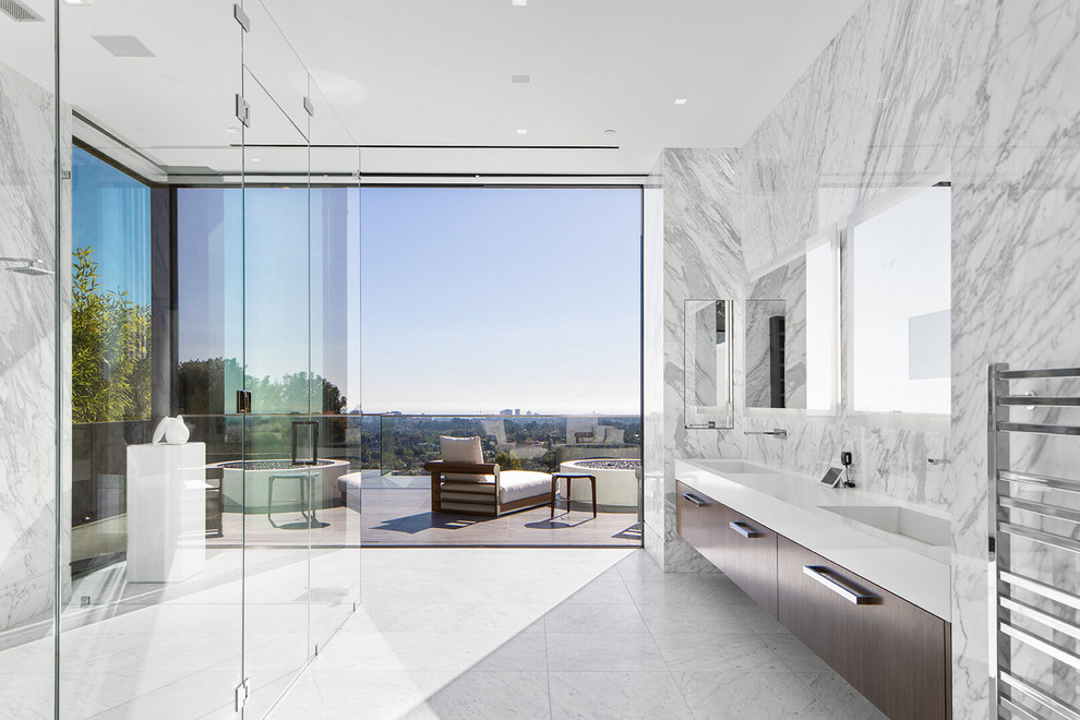 Design ideas for a contemporary master bathroom in Los Angeles with flat-panel cabinets, dark wood cabinets, a curbless shower, white tile, stone slab, an integrated sink, white floor, a hinged shower door, white benchtops, a double vanity and a floating vanity.