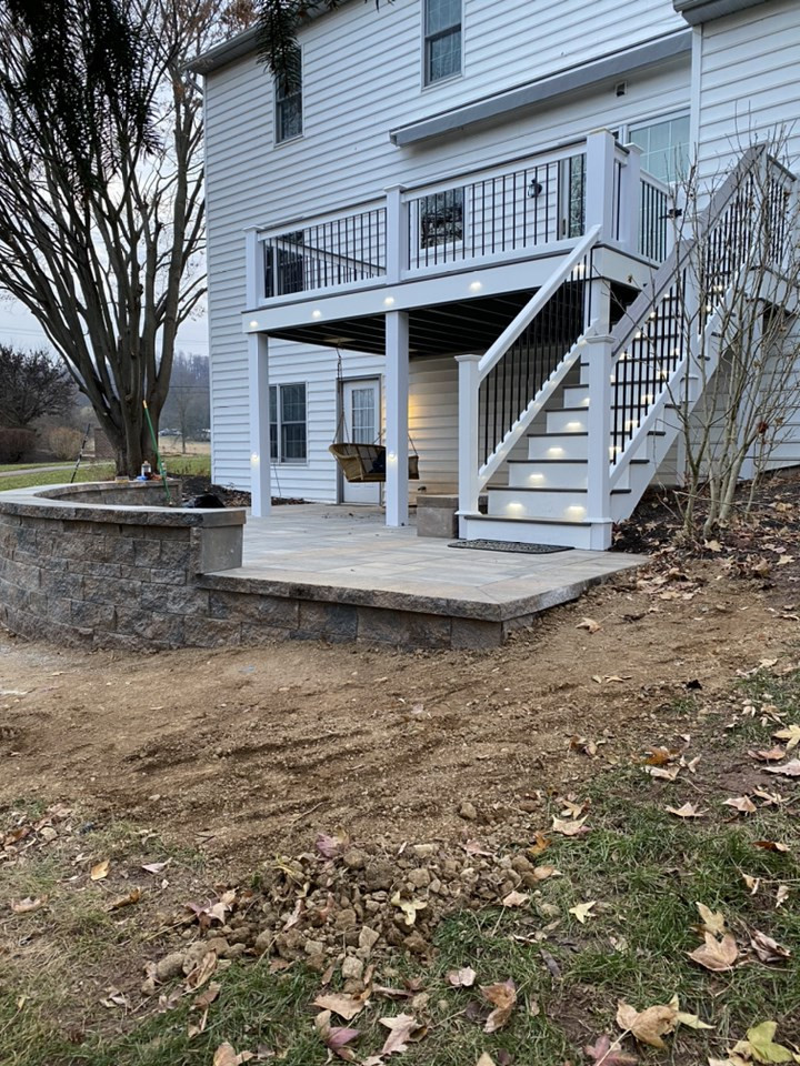 This is an example of a mid-sized transitional backyard and first floor deck in Other with no cover and mixed railing.