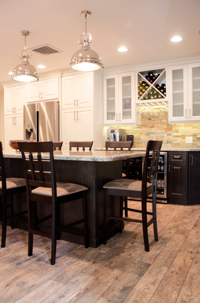 Large mountain style medium tone wood floor open concept kitchen photo in Miami with granite countertops, multicolored backsplash, stone tile backsplash, stainless steel appliances and an island
