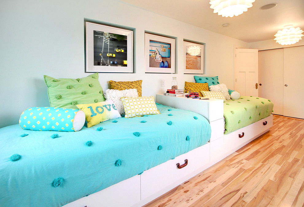 Contemporary kids' room in Seattle with white walls and light hardwood floors for girls.