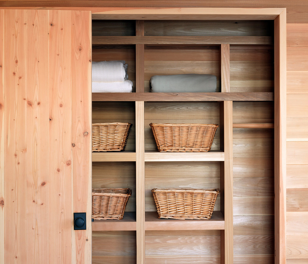 Country gender-neutral built-in wardrobe in Burlington with light wood cabinets.