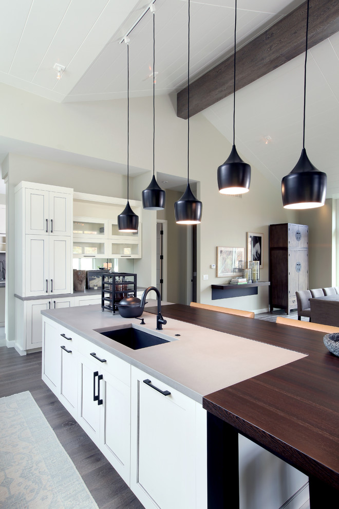 Inspiration for a large transitional l-shaped open plan kitchen in Grand Rapids with an undermount sink, beaded inset cabinets, white cabinets, concrete benchtops, panelled appliances, medium hardwood floors and with island.