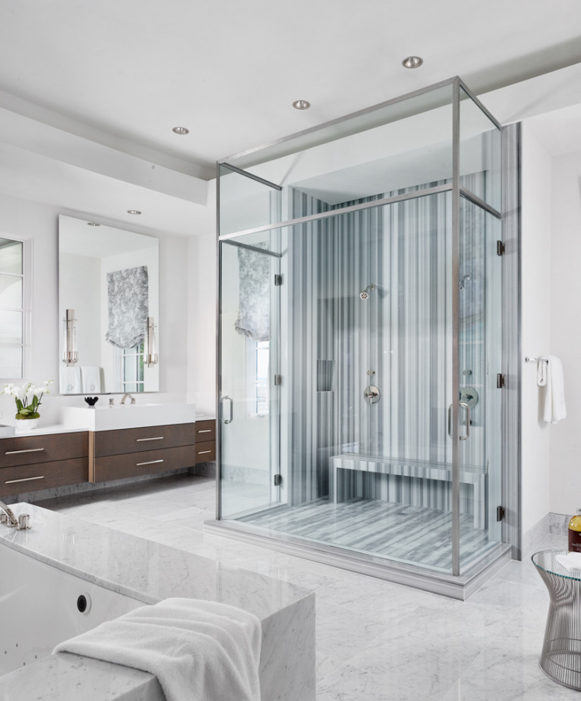 Small contemporary master wet room bathroom in Austin with flat-panel cabinets, brown cabinets, a drop-in tub, white tile, white walls, a drop-in sink, white floor, a hinged shower door, white benchtops, a shower seat, a double vanity and a built-in vanity.