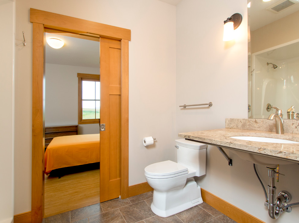 Inspiration for a large transitional 3/4 brown tile and ceramic tile ceramic tile bathroom remodel with an undermount sink, quartz countertops and beige walls