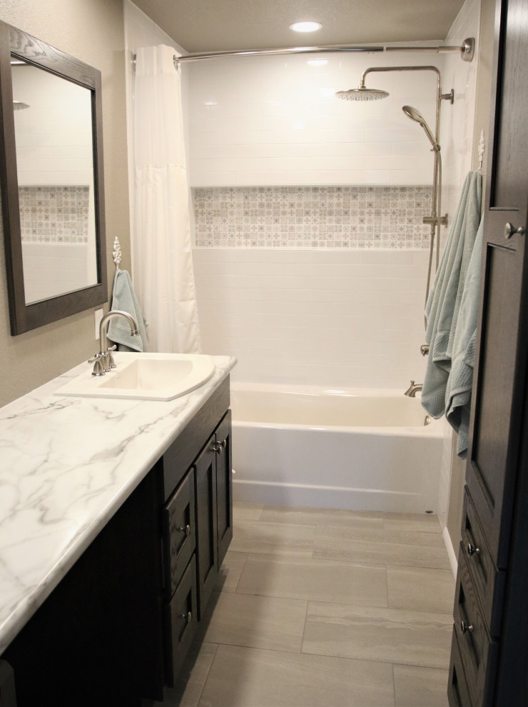 Design ideas for a mid-sized transitional master bathroom in Other with shaker cabinets, dark wood cabinets, an alcove tub, a shower/bathtub combo, a one-piece toilet, white tile, ceramic tile, beige walls, porcelain floors, a drop-in sink, laminate benchtops, grey floor, a shower curtain, white benchtops, a niche, a single vanity and a built-in vanity.