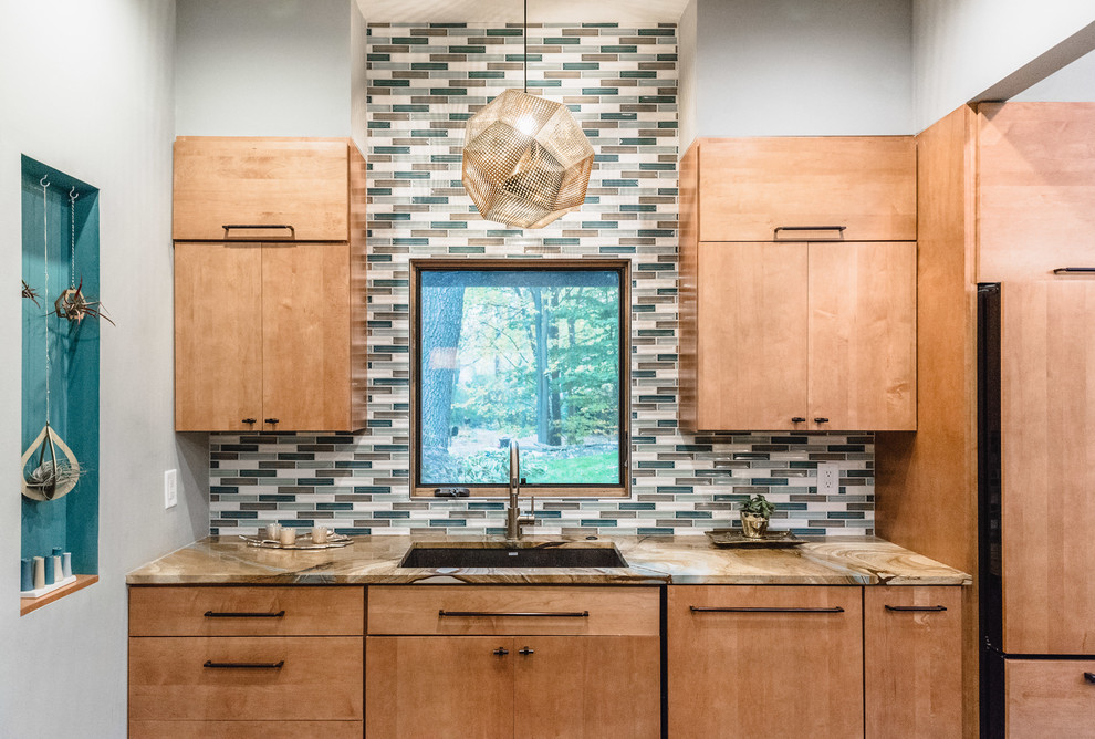 Design ideas for a mid-sized midcentury l-shaped eat-in kitchen in Detroit with a single-bowl sink, flat-panel cabinets, medium wood cabinets, quartzite benchtops, multi-coloured splashback, ceramic splashback, black appliances, slate floors, with island and multi-coloured floor.