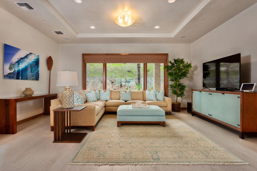 Design ideas for a mid-sized contemporary enclosed family room in Hawaii with beige walls, light hardwood floors, no fireplace, a freestanding tv and beige floor.