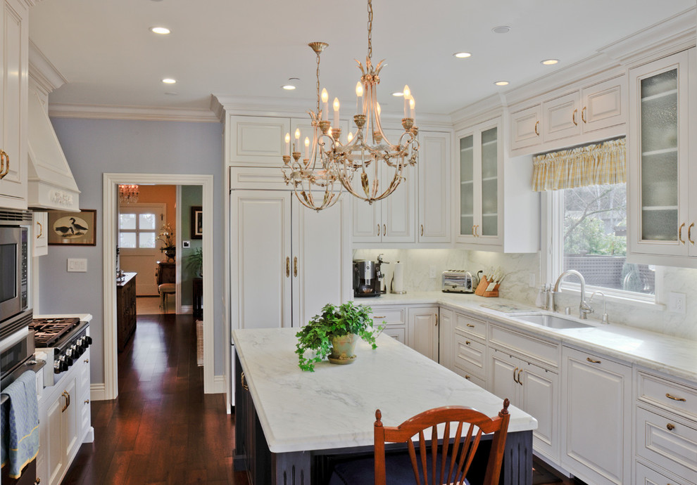 This is an example of a traditional kitchen in San Francisco with raised-panel cabinets and white cabinets.