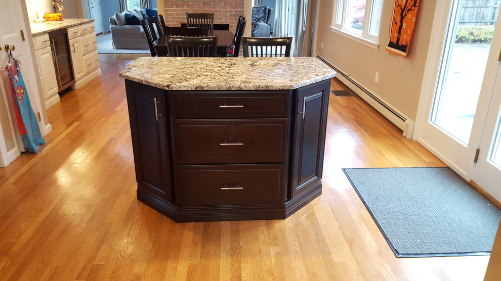 Large transitional l-shaped light wood floor eat-in kitchen photo in Boston with an undermount sink, raised-panel cabinets, white cabinets, granite countertops, gray backsplash, ceramic backsplash, stainless steel appliances and an island