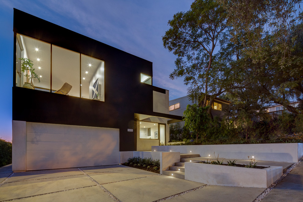 Photo of a large contemporary two-storey black house exterior in Los Angeles with concrete fiberboard siding, a flat roof and a mixed roof.