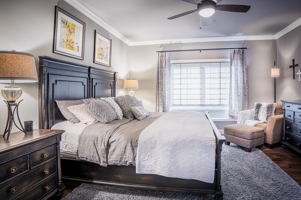 Mid-sized transitional dark wood floor and brown floor bedroom photo with gray walls and no fireplace
