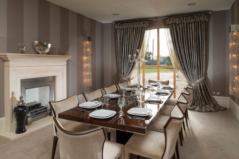 Inspiration for a transitional dining room in West Midlands with carpet, a standard fireplace, a metal fireplace surround and brown walls.