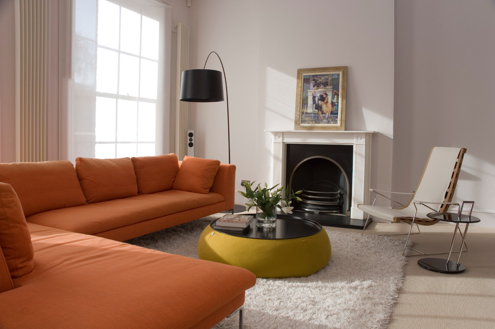 Inspiration for a contemporary formal living room in London with white walls, carpet and a standard fireplace.