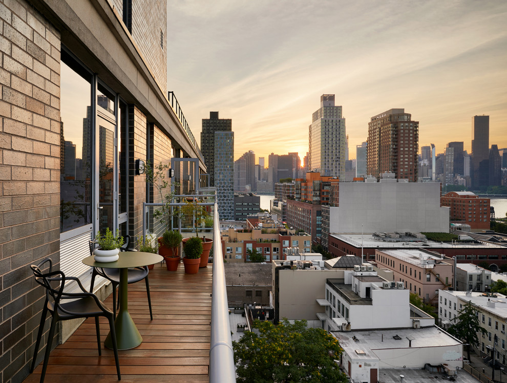 Inspiration for a small contemporary balcony in New York with no cover and glass railing.